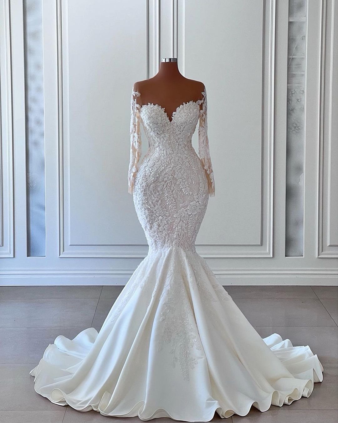 White mermaid wedding dress with sweetheart neckline and long illusion lace sleeves.