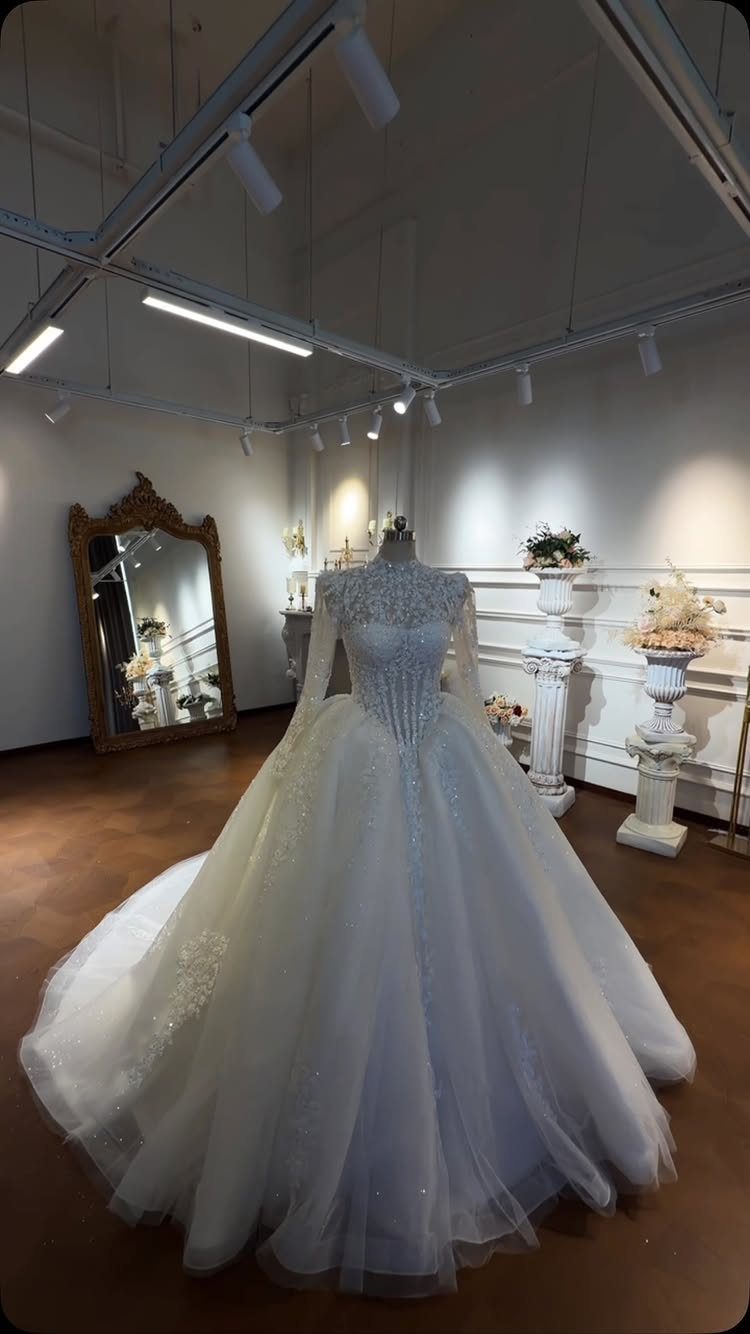 White ball gown wedding dress with lace bodice on a mannequin in boutique