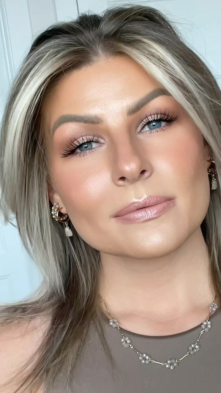 Woman with pale skin wearing soft dusty rose lipstick and bridal makeup.