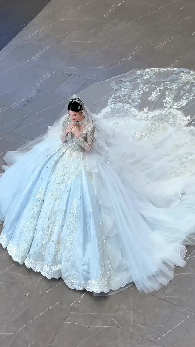 Woman in a light blue wedding gown with a long cathedral train