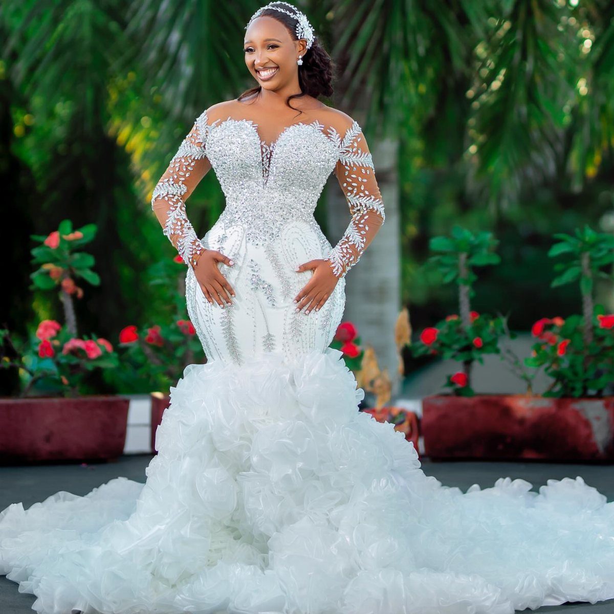 Bride in a white beaded wedding dress with a long ruffled cathedral train.