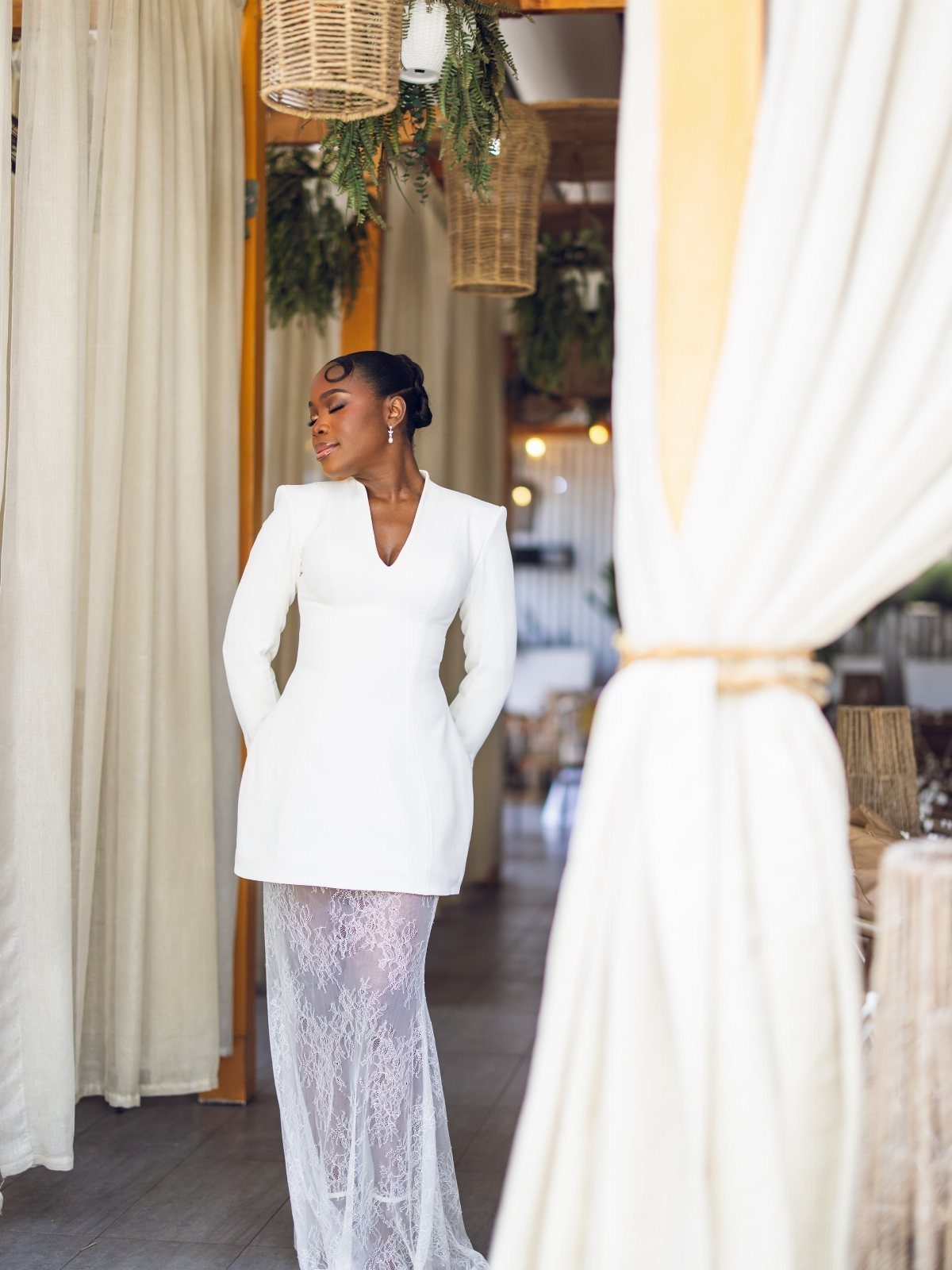 Woman in a white tailored blazer and long sheer lace wedding skirt