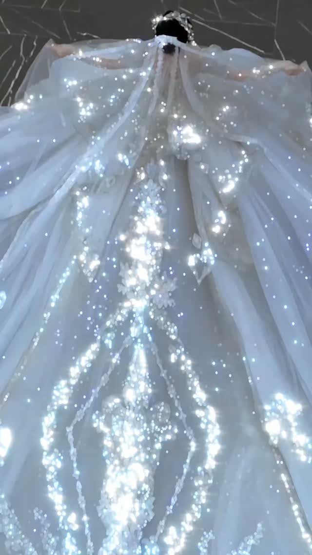 Sparkly white ball gown wedding dress with shimmering sequins and a long train.