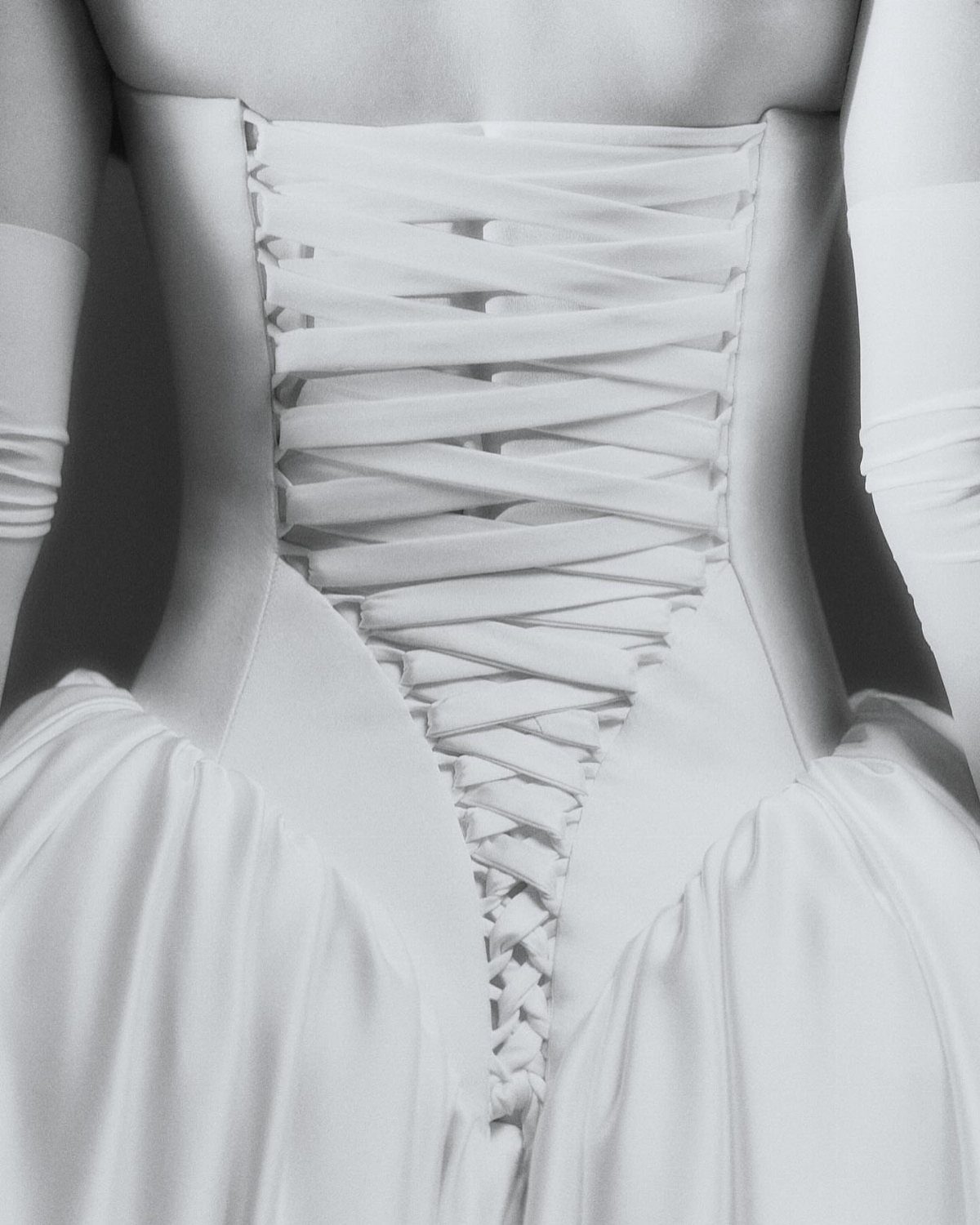 White wedding dress back with a long corset lace-up closure and drop waist.
