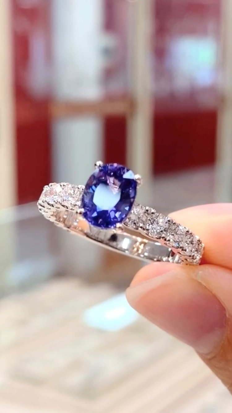 Silver engagement ring with a large oval purple sapphire and diamond accents