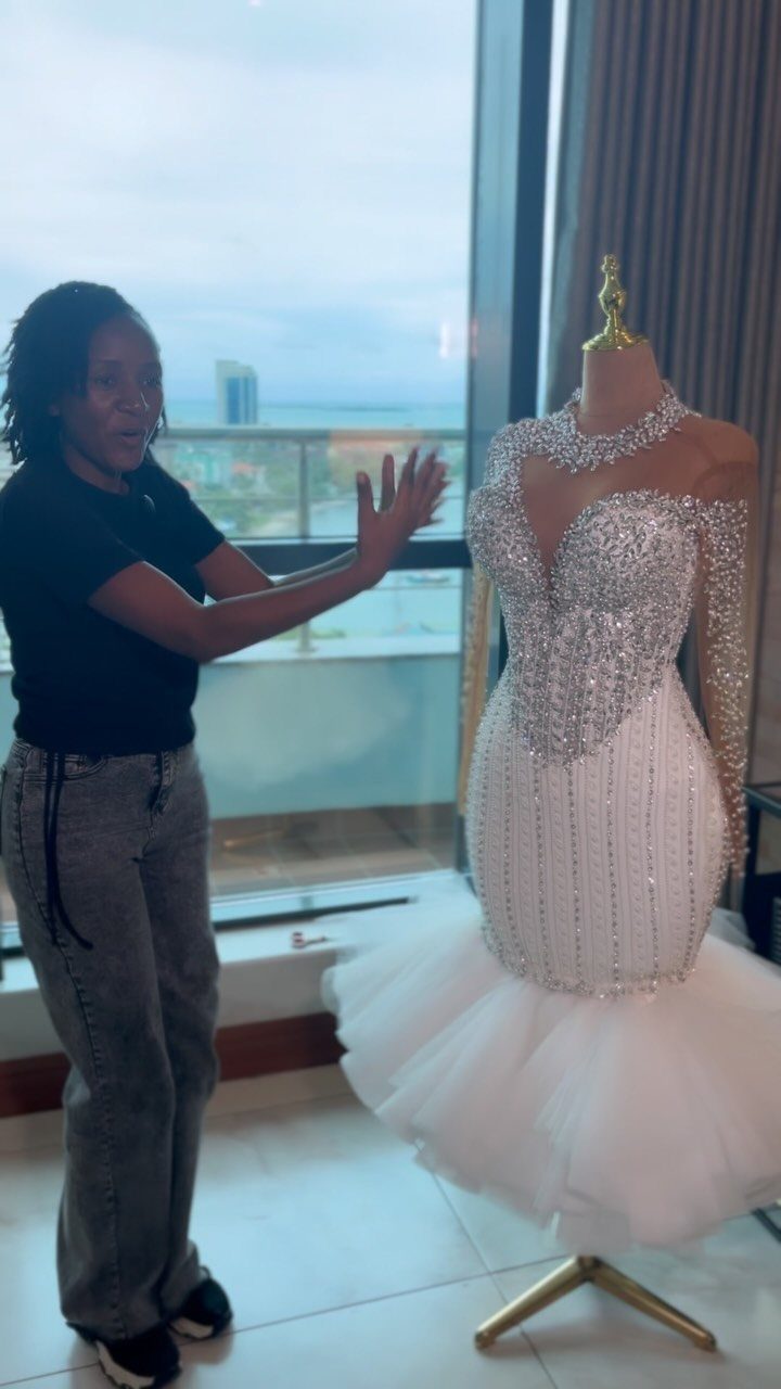 White mermaid wedding dress with heavy silver beading on a mannequin.