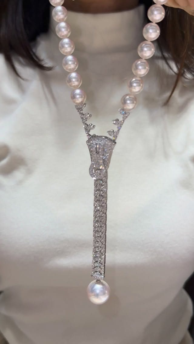 Bold pearl and diamond necklace worn with a white high-neck top