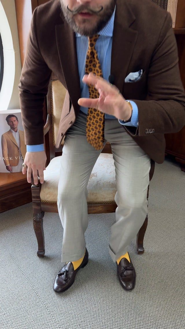 Man wearing a brown blazer, leopard print tie, and beige trousers for summer wedding.