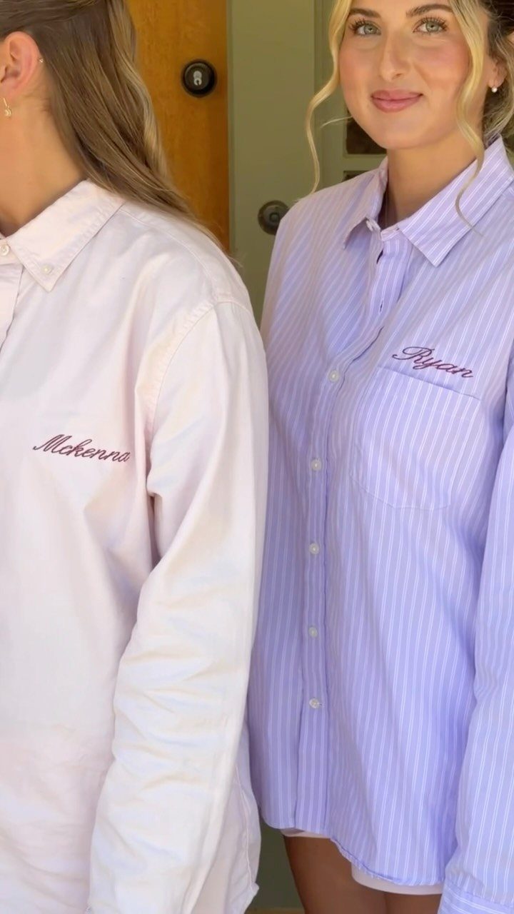 Two women wearing personalized white and purple button-down shirts for a wedding morning.