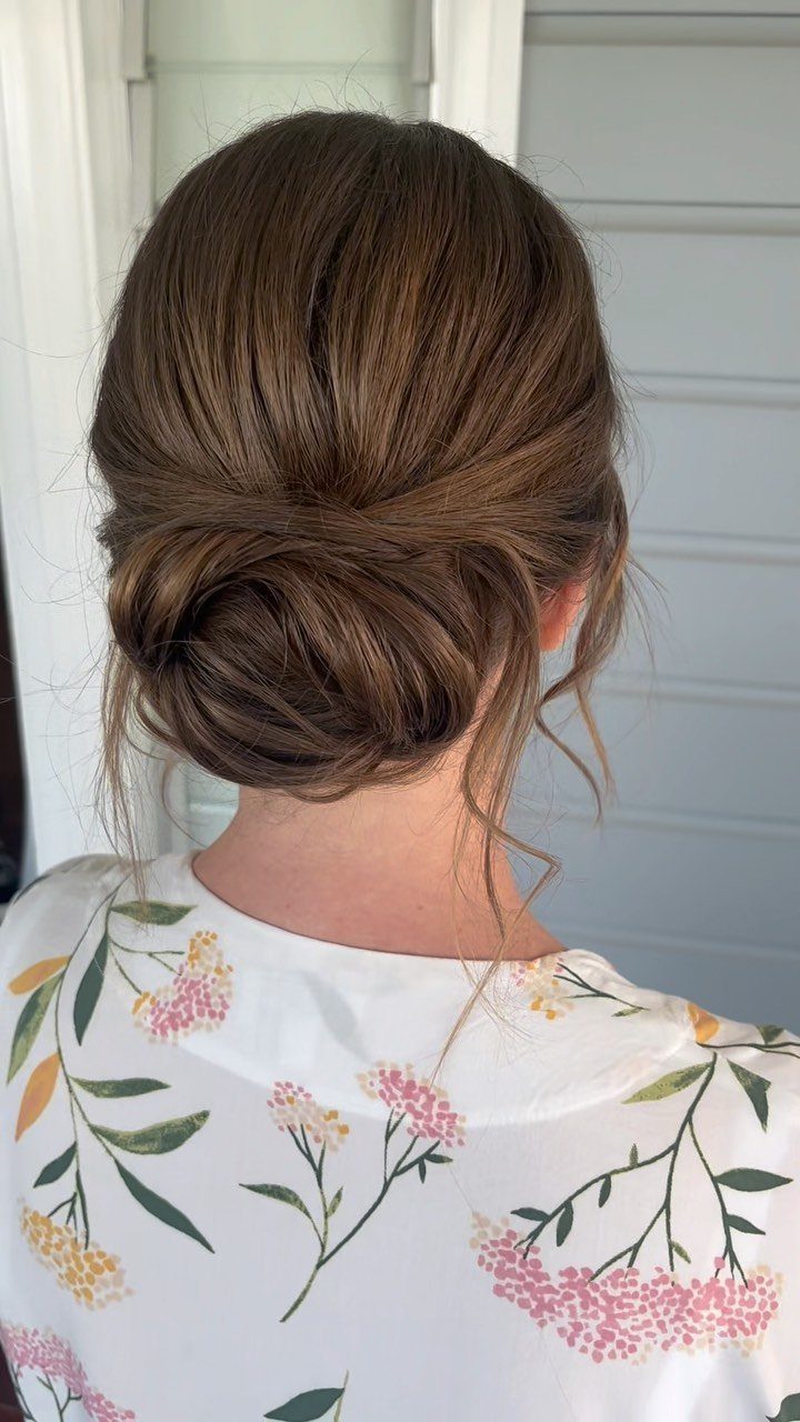 Brown hair styled in a low bun with volume at the crown.