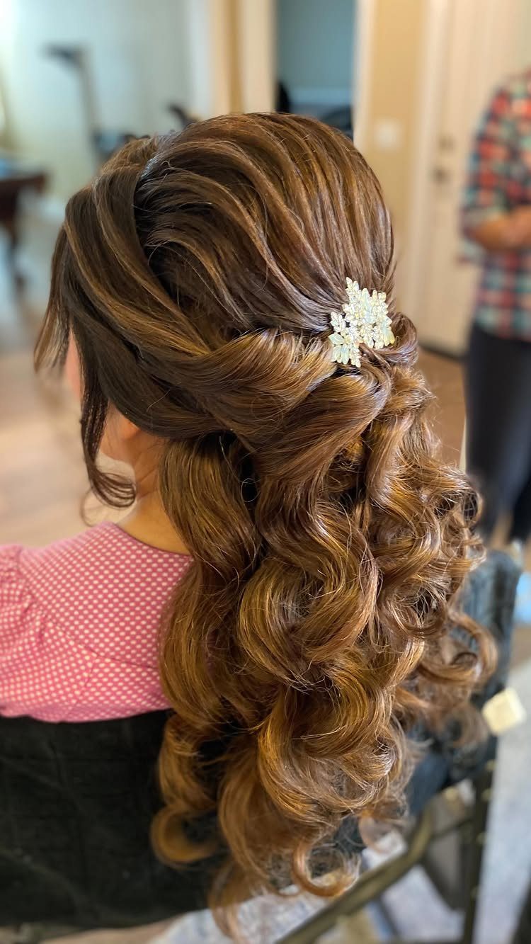 Brown hair styled in side-swept Hollywood waves with a sparkling silver hair clip.