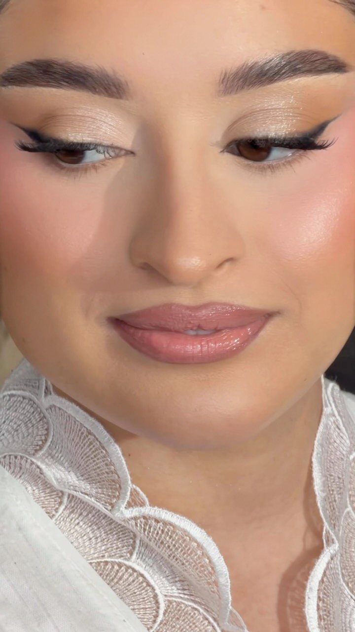 Woman with bridal makeup featuring soft shimmer on the inner corners of her eyes.