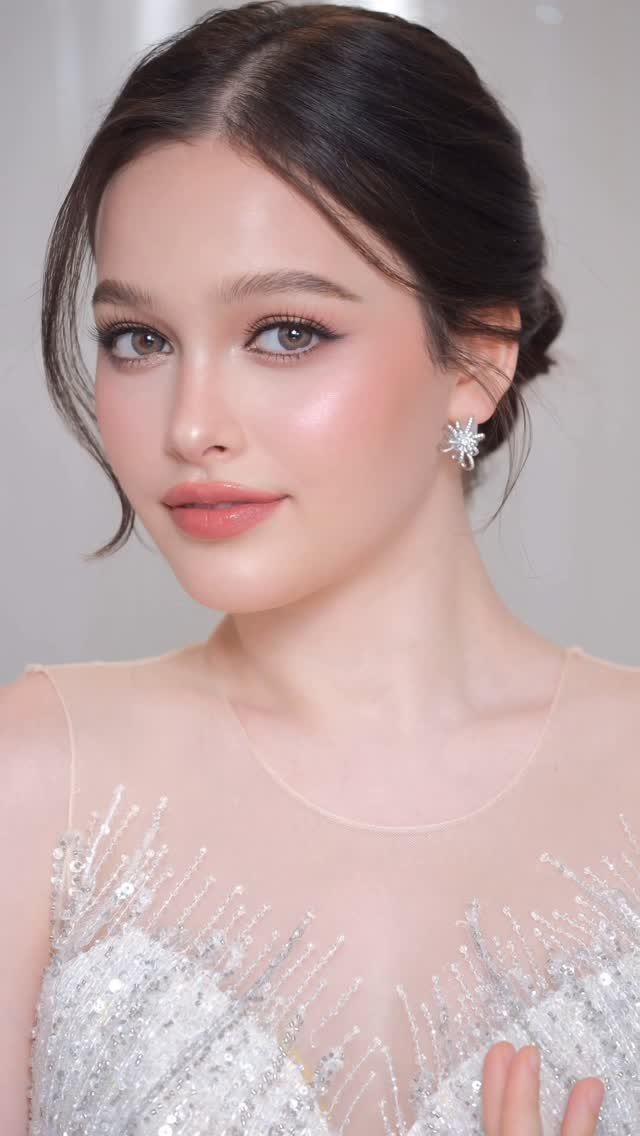 Woman with soft glam bridal makeup wearing a white sequined wedding dress.