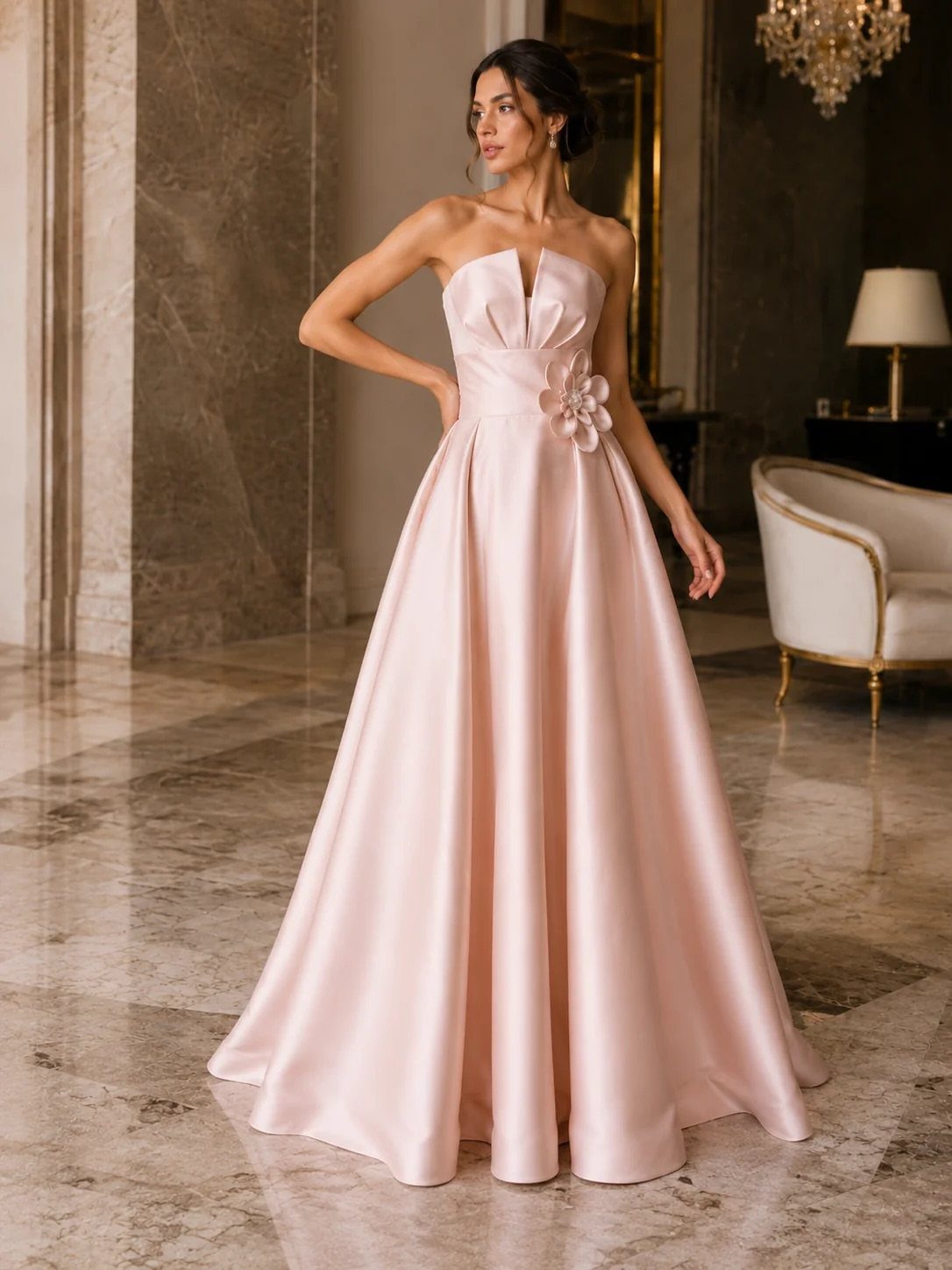 Woman in a pale pink satin strapless gown with 3D floral waist detail.