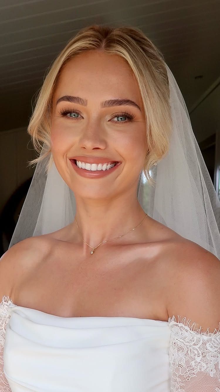 Bride with soft glam makeup and nude lips wearing a white wedding dress