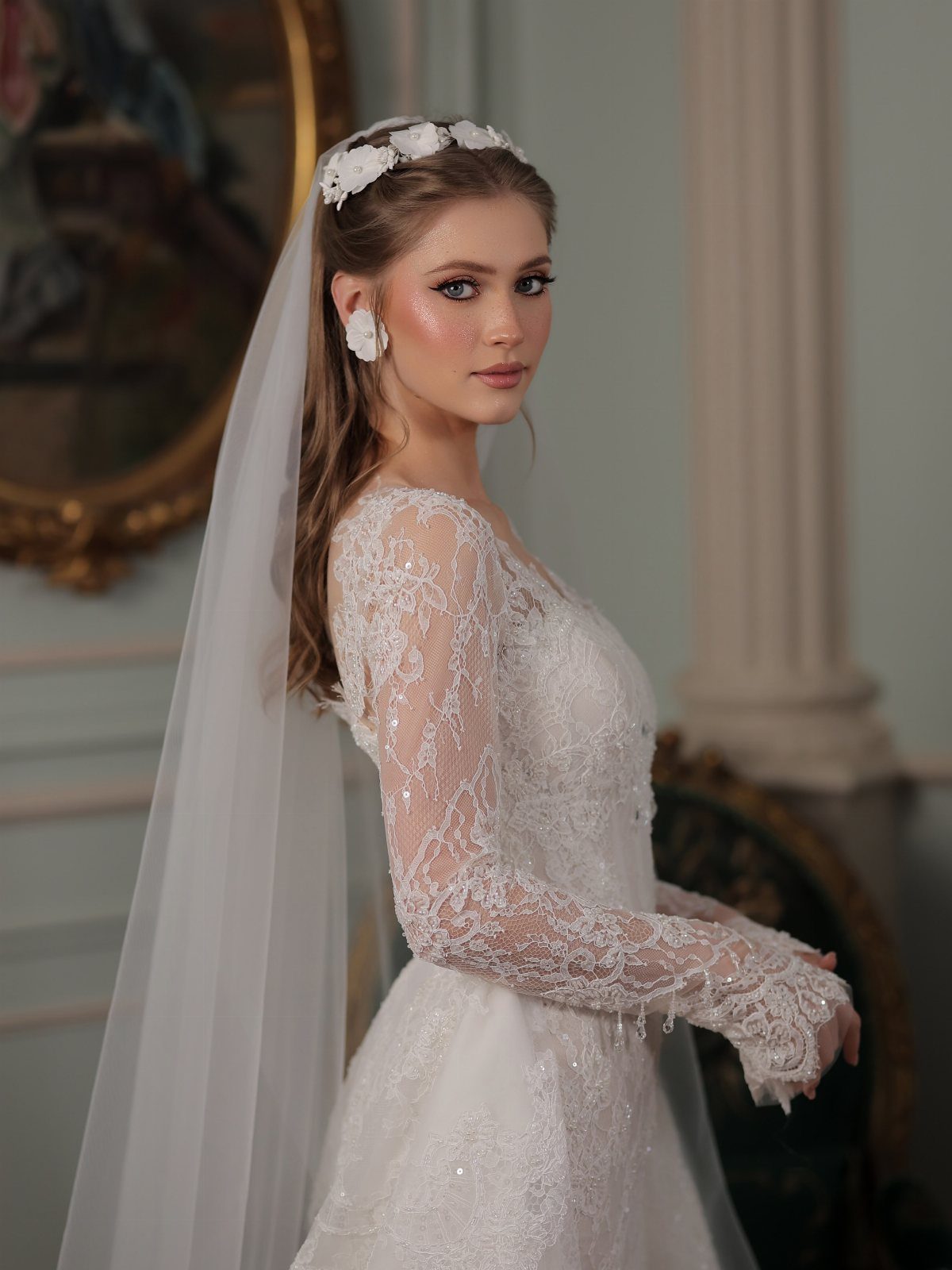 Bride in lace gown with romantic soft glam makeup and floral accessories