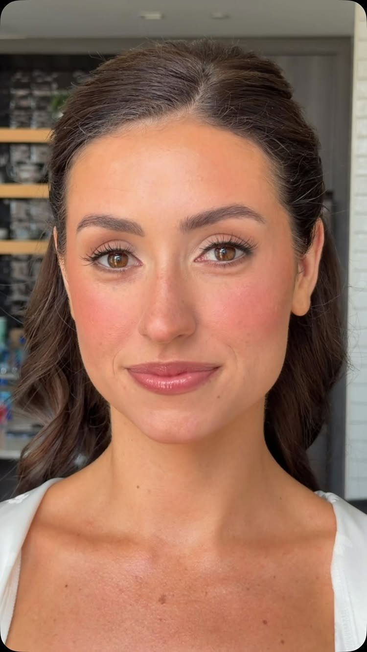Woman with natural glam wedding makeup, featuring neutral tones and glowing skin.