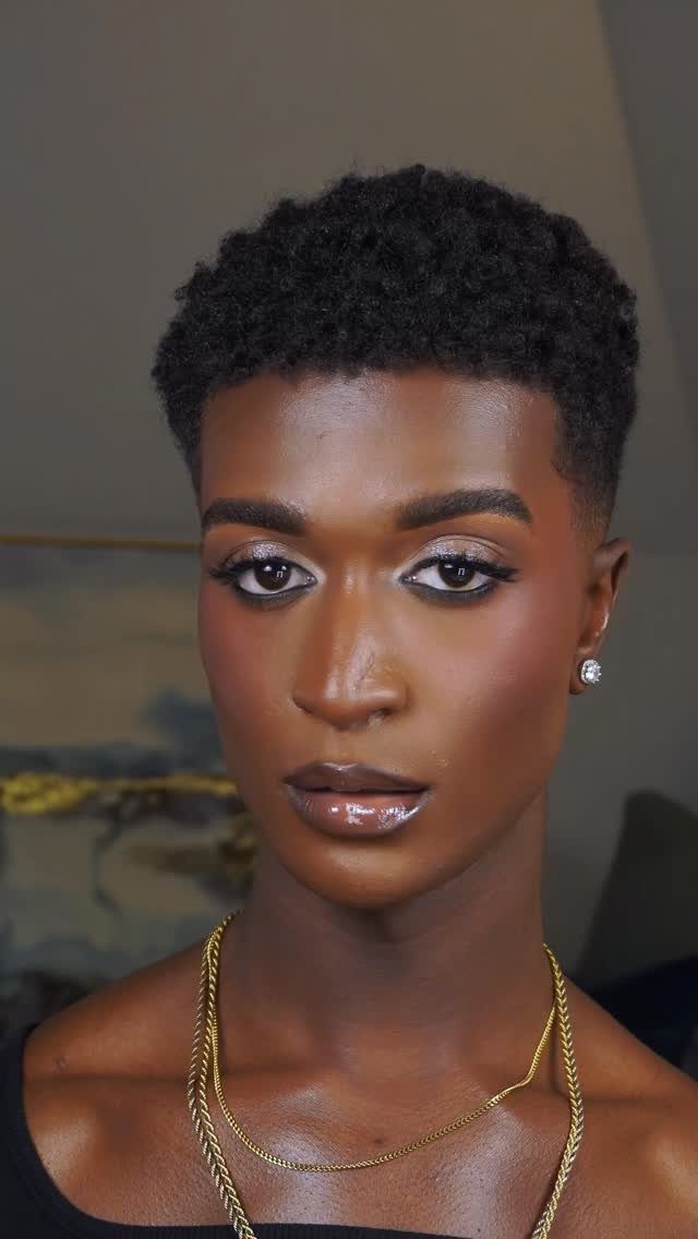 Person with tan skin wearing shimmering wedding makeup and gold jewelry
