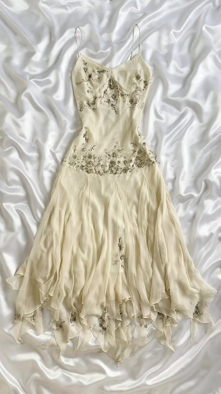 Cream vintage wedding dress with floral embroidery on white satin fabric