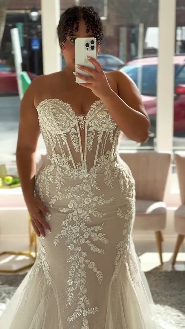 Woman in a strapless white lace mermaid wedding dress with a corset bodice.