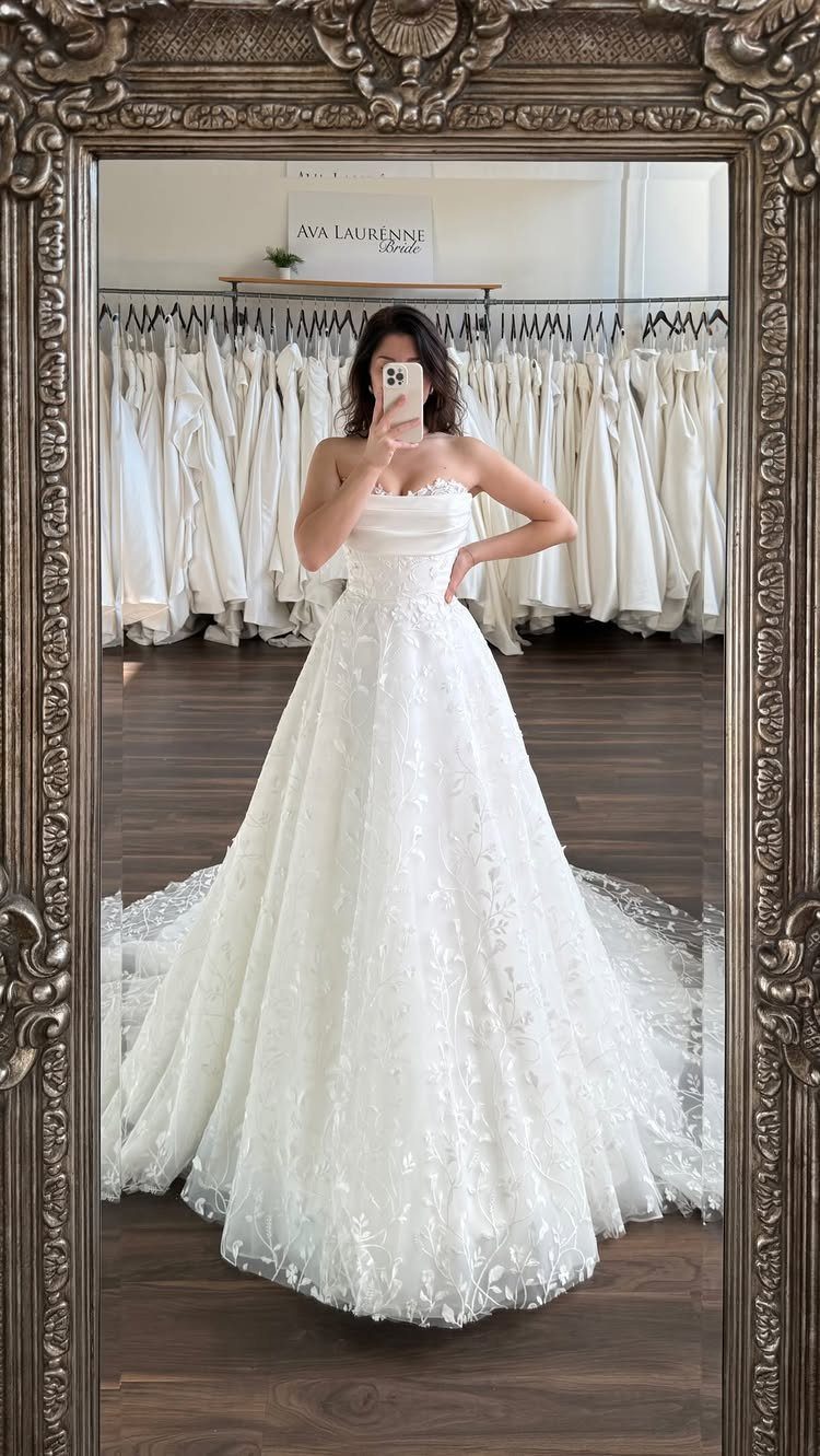Woman in a white lace A-line wedding dress with a sweetheart neckline.
