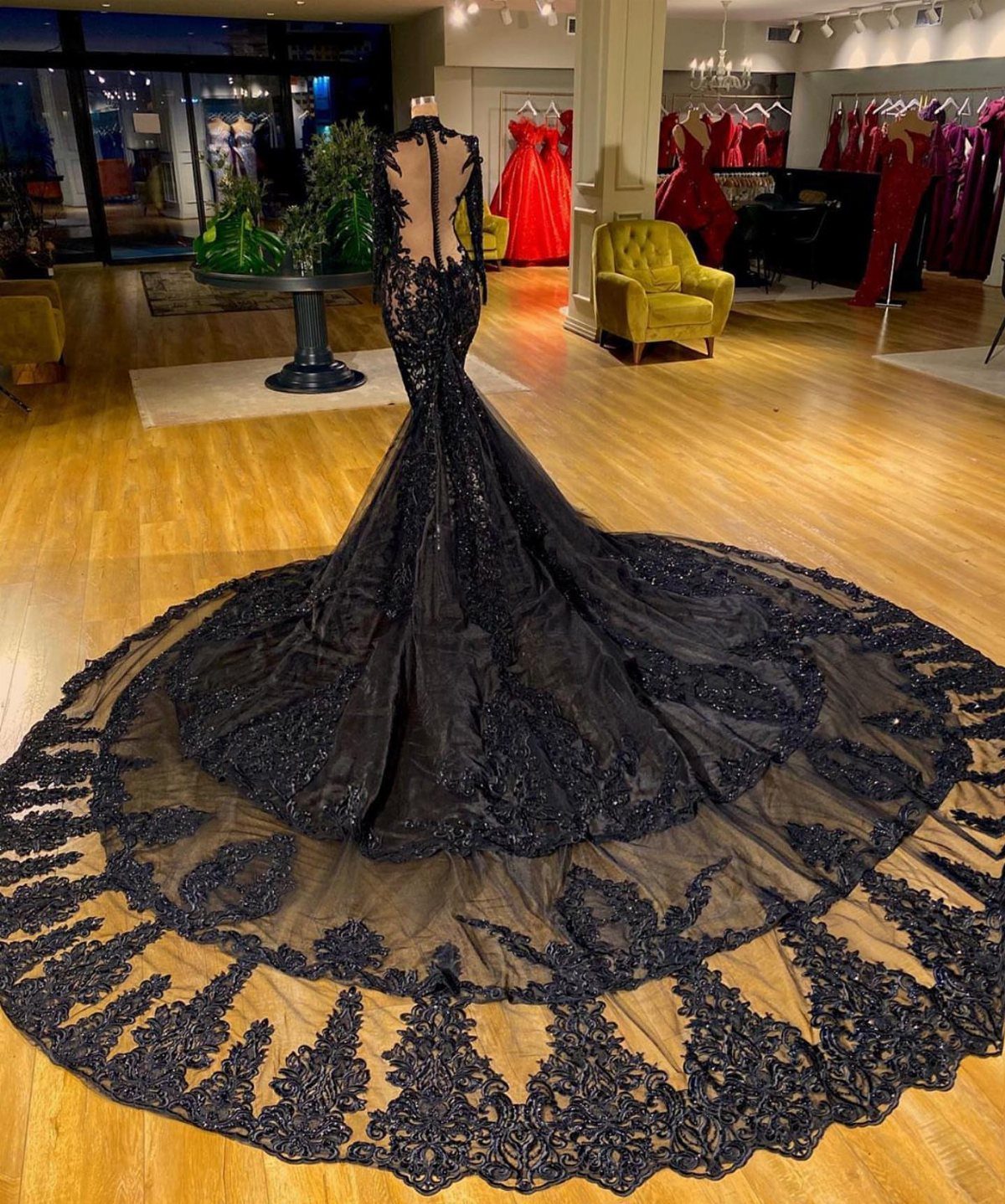 Black mermaid wedding dress with lace embroidery and a long circular train.