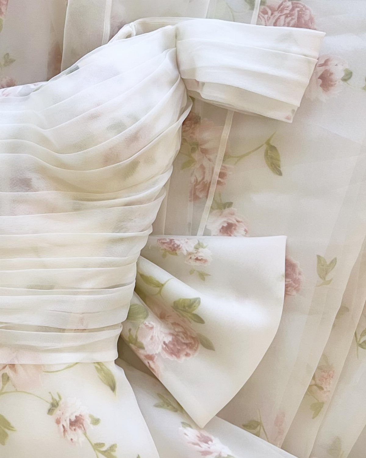 White dress with pleated bodice and pink rose floral print patterns