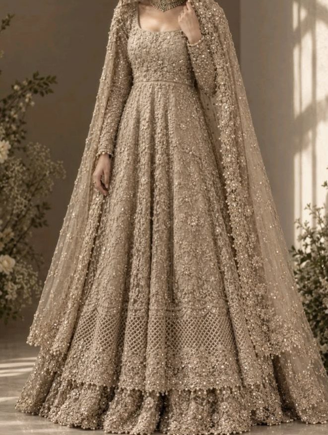 Champagne-colored embroidered wedding gown with a matching sheer cape and gold sequins.