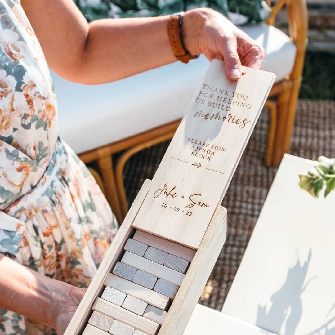 Wooden Jenga block guest book box with engraved wedding message and names.