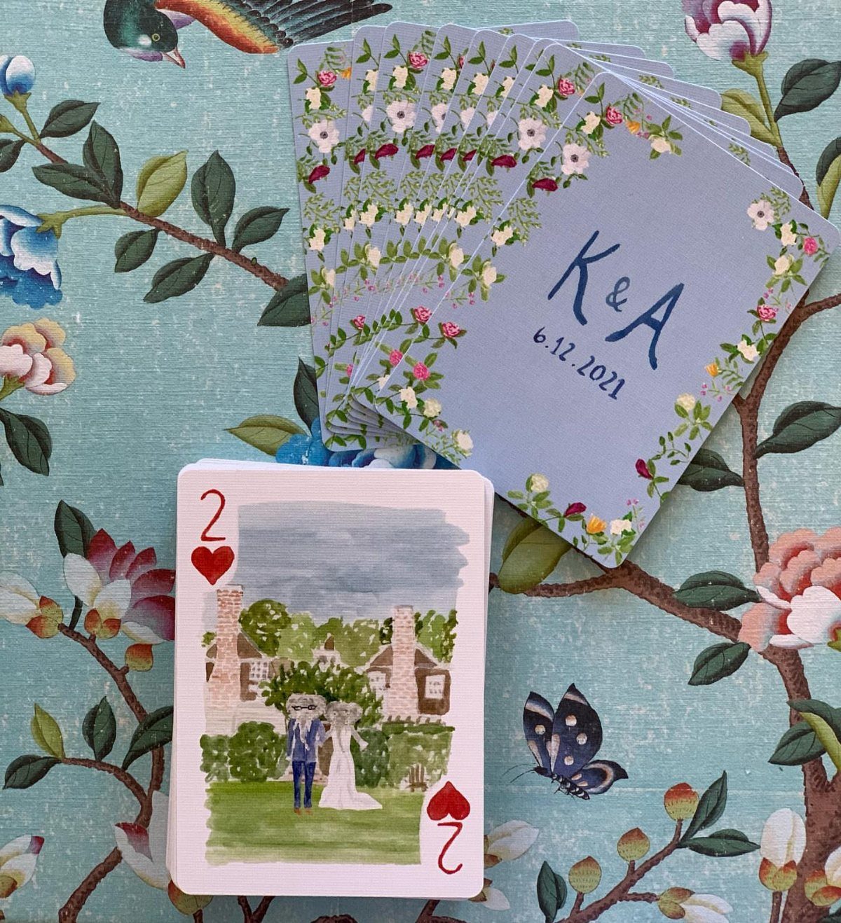 Custom playing cards with watercolor wedding illustrations and personalized floral backs.